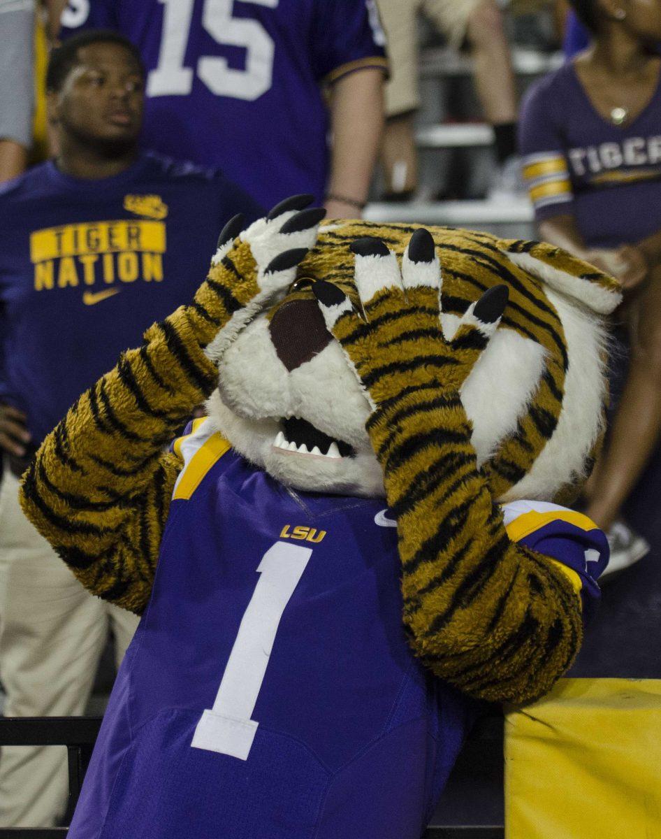 Mike the Tiger shields his eyes from the score during the Tigers' 24-21 loss against Troy in Tiger Stadium on Saturday, Sept. 30, 2017.