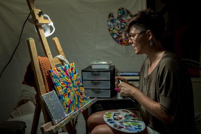 International studies senior Sam Prather paints in her home on Sunday, Oct. 1, 2017.