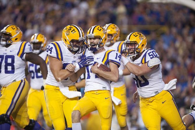 <p>LSU junior punter Trent Domingue (14) celebrates with his teammates after scoring a touchdown on Saturday, Oct. 17, 2015, during the Tigers' 35-28 victory against Florida in Tiger Stadium.</p>