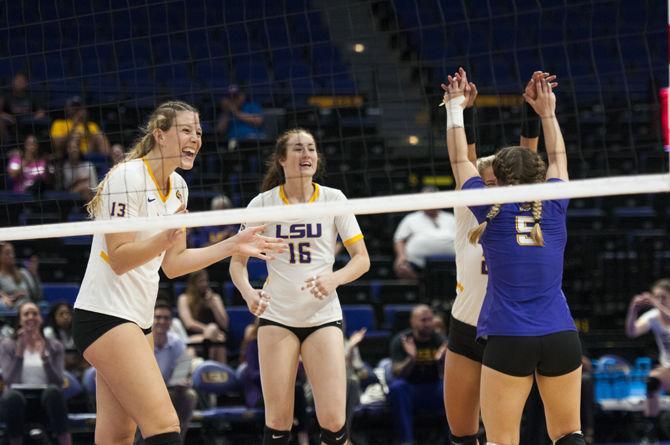 The volleyball team celebrates after score a point during the Lady Tigers' 3-1 victory over the University of Alabama on Sunday, Oct. 15, 2017, in the Pete Maravich Assembly Center.