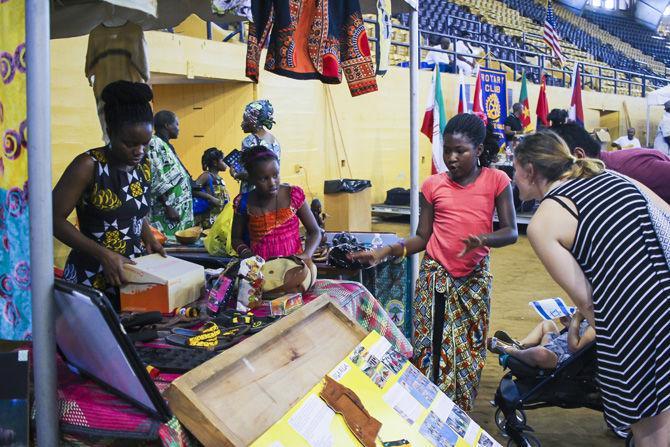 Representatives of the country of Uganda speak to interested visitors about their country on Sunday, Oct. 16, 2016 at the John M. Parker Coliseum.