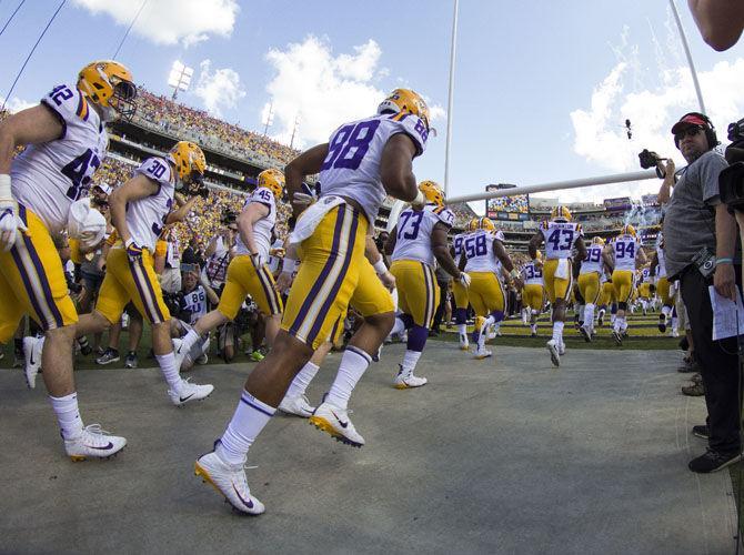 The LSU football team runs onto the field before the Tigers' 27-23 victory against Auburn on Saturday, Oct. 14, 2017, in Tiger Stadium.