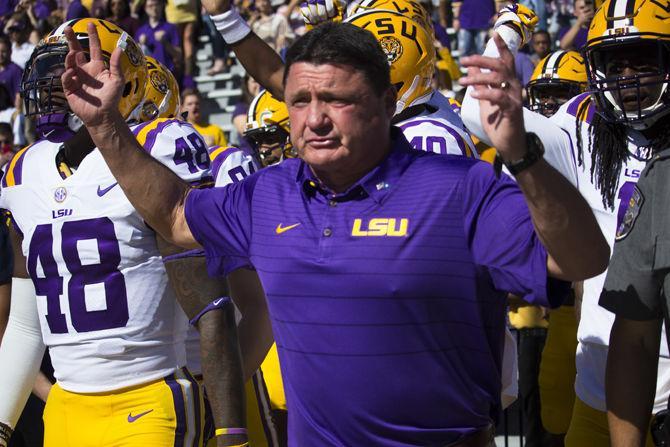 LSU Head Coach Ed Orgeron leads the LSU football players out to the field during the Tigers&#8217; 33-10 victory against Arkansas on Saturday, Nov. 11, 2017, in Tiger Stadium.