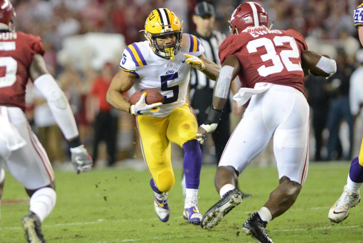 LSU junior running back Derrius Guice (5) advances the ball downfield against Alabama senior linebacker Rashaan Evans (32) during the Tigers' 24-10 loss against Alabama on Nov. 4, 2017, at Bryant-Denny Stadium.