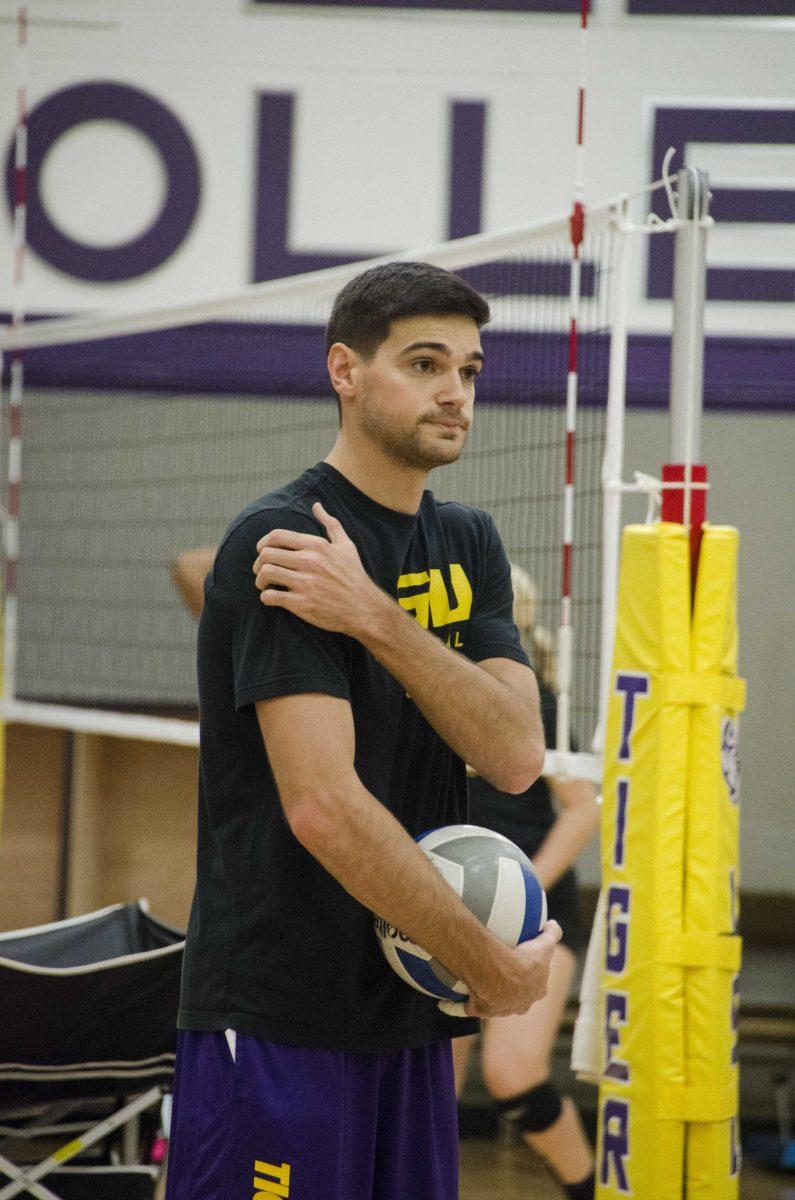 Assistant coach Ethan Pheister helps with drills at volleyball practice on Tuesday, Nov. 7, 2017, in the PMAC Practice Facility.