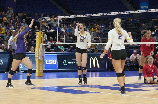 LSU freshman defensive specialist Raigen Cianciulli (5) (left), junior outside hitter Toni Rodriguez (25) (middle), and sophomore setter Anna Zwiebel (2) (right) celebrate during the Lady Tigers' 3-0 win over the University of Houston on Saturday, Sept. 15, 2017, at the Pete Maravich Assembly Center.