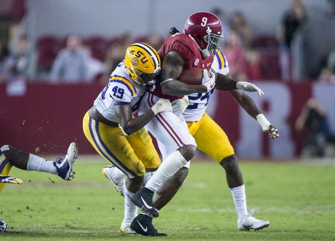 LSU junior linebacker Arden Key (49) tackles Alabama junior running back Bo Scarbrough (9) during the Tigers' 24-10 loss against Alabama on Nov. 4, 2017, at Bryant-Denny Stadium.