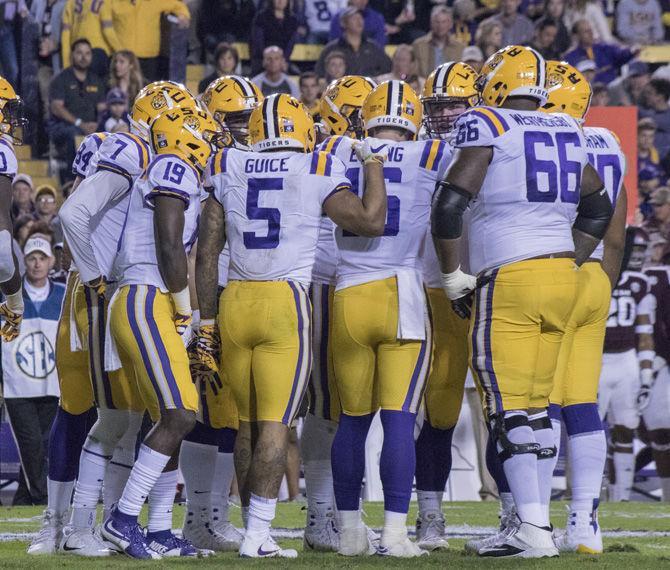 LSU offense discusses play during the Tigers&#8217; 45-21 victory against Texas A&amp;M on Saturday, Nov. 25, 2017, in Tiger Stadium.