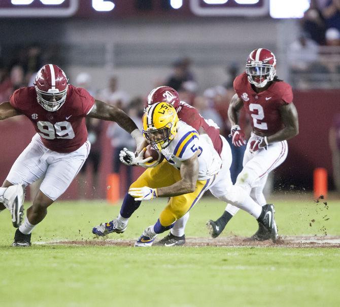 LSU junior running back Derrius Guice (5) attempts to escape Alabama's defense during the Tigers' 10-24 loss to the University of Alabama on Saturday, Nov. 4, 2017, in Bryant&#8211;Denny Stadium in Tuscaloosa.