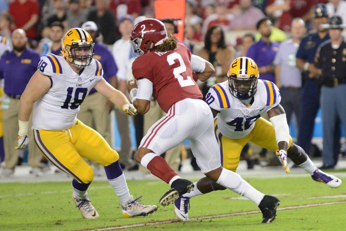 LSU senior defensive end Christian LaCouture (18) and sophomore linebacker Devin White (40) rush after Alabama sophomore quarterback Jalen Hurts (2) during the Tigers' 24-10 loss against Alabama on Nov. 4, 2017, at Bryant-Denny Stadium.