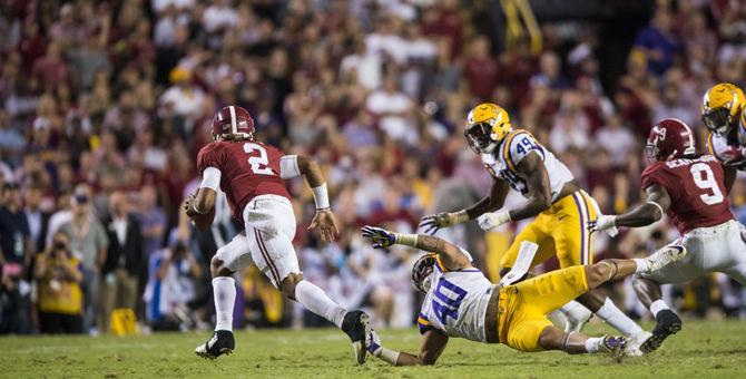 LSU seniro linebacker Duke Riley (40) attempts to tackle Alabama freshman quarterback Jalen Hurts (2) as he runs during the Tigers 10-0 loss against Alabama on Saturday Nov. 5, 2016, in Tiger Stadium.