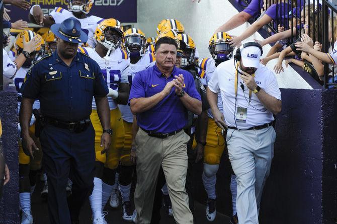 LSU football coach Ed Orgeron leads the team onto the field before the Tigers' 35-26 victory against Syracuse on Saturday, Sept. 23, 2017, in Tiger Stadium.