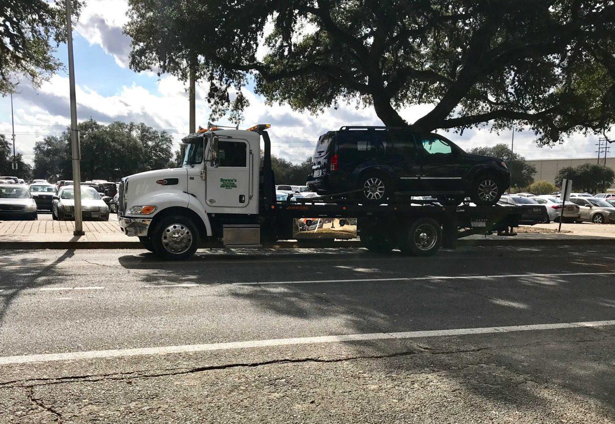 One of the vehicles involved in an incident on South Stadium Drive is towed away on Dec. 5, 2017.