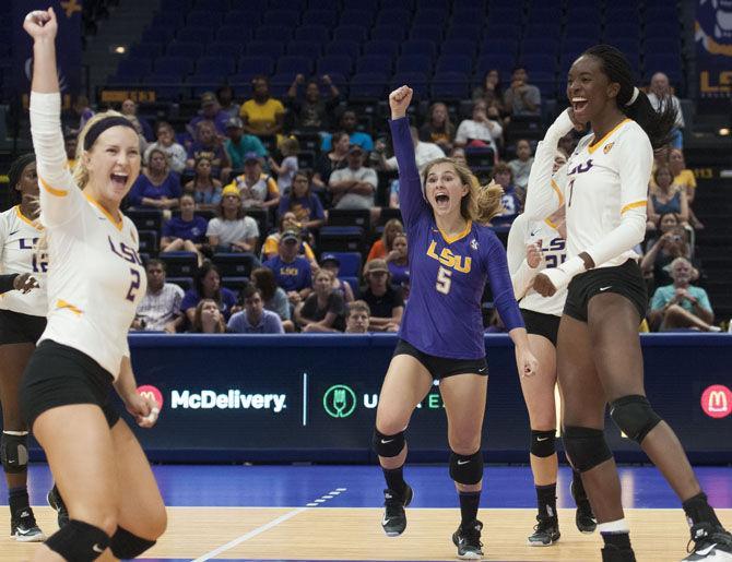 LSU sophomore setter Anna Zwiebel (2) (left), freshman defensive specialist Raigen Cianciulli (5) (middle), and freshman middle blocker and outside hitter Taylor Bannister (7) (right) celebrate a point during the Lady Tigers' 3-0 win over the University of Houston on Saturday, Sept. 15, 2017, at the Pete Maravich Assembly Center.