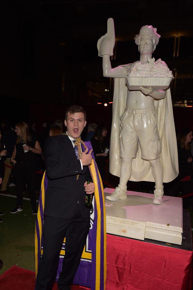 Senior Christian Christoffersen stands in front of a statue he was awarded at the College Football Playoff National Championship Game in Atlanta, Georgia on Jan. 8, 2018.&#160;