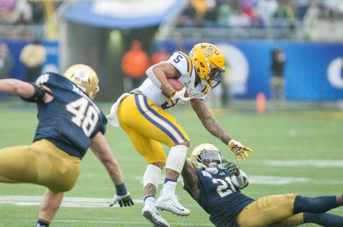 LSU junior running back Derrius Guice (5) runs the ball during the Tigers' 17-21 loss to Notre Dame in the Citrus Bowl on Monday, Jan. 1, 2018 in Camping World Stadium in Orlando, Florida.