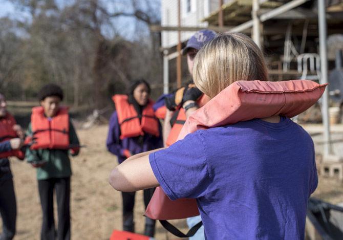 Volunteer LSU canoes Bayou Manchac in cleanup effort