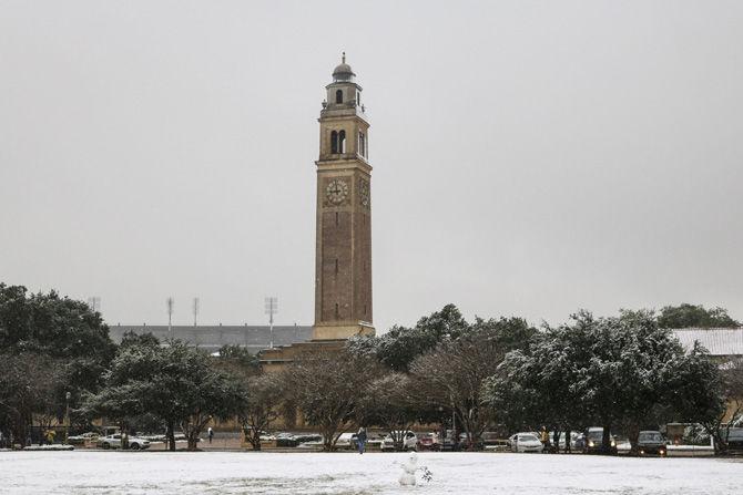 Memorial Tower takes on snowfall on Friday, Dec. 8, 2017.