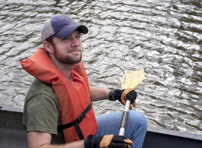 Volunteer LSU canoes Bayou Manchac in cleanup effort