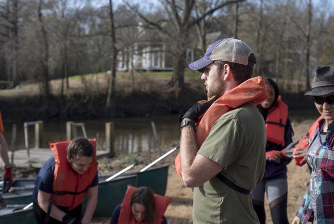 Volunteer LSU canoes Bayou Manchac in cleanup effort