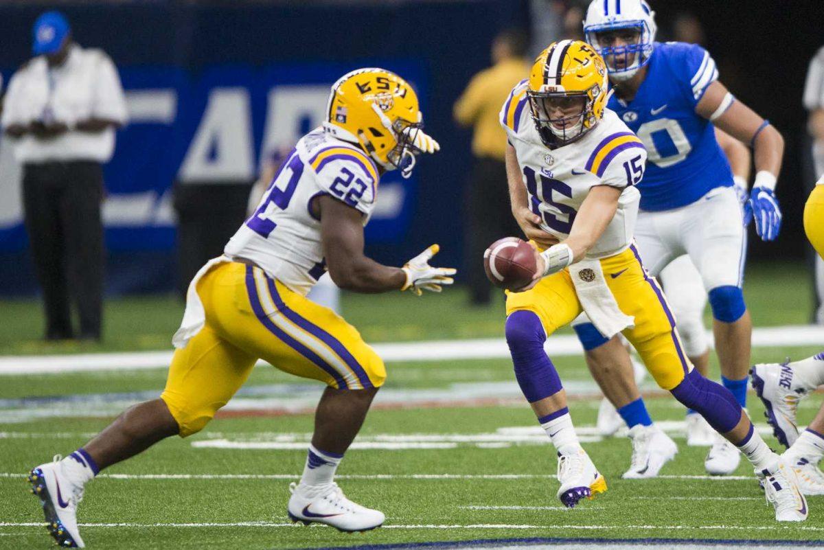 LSU freshman quarterback Myles Brennan (15) hands the ball off to freshman running back Clyde Edwards-Helaire (22) during LSU's 27-0 win against BYU on Saturday, Sept. 2, 2017, at the Mercedes-Benz Superdome in New Orleans.