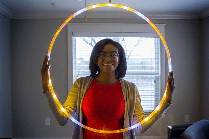 LSU psychology senior Andrea Smith hula-hoops with an LED hoop in her living room to fight the rainy day blues on Saturday, Feb. 10, 2018.