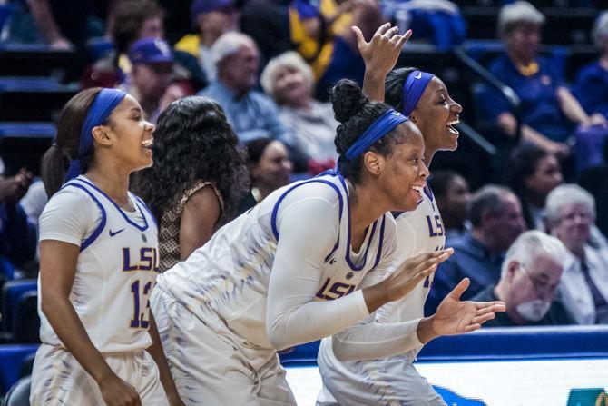 (from left to right) LSU sophomore guard Jaelyn Richard-Harris (13), LSU freshman center Faustine Aifuwa (24) and LSU senior guard Raigyne Louis (11) cheer on their team from the sideline during the Tigers' 79-78 win against Alabama on Sunday,&#160;Feb. 25, 2018, in the PMAC.