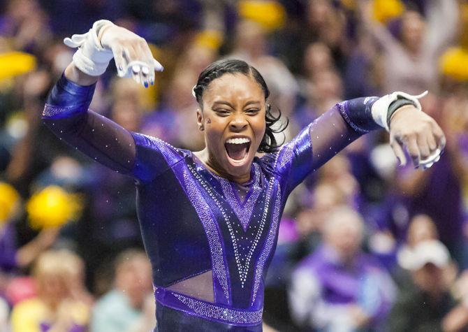 LSU sophomore Kennedi Edney lands her uneven bars routine and celebrates during the Tigers' 197.15-195.350 victory against Arkansas on Friday, Jan. 5, 2018, in the PMAC.