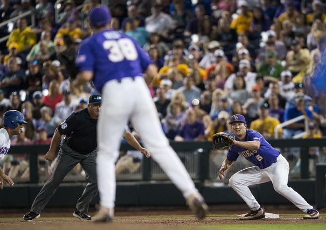 LSU freshman infielder Jake Slaughter (5) waits at first base for freshman pitcher Zack Hess's (38) pass during LSU's 6-1 loss to Florida in game two of the College World Series on Tuesday June 27, 2017, at the TD Ameritrade Center in Omaha, Nebraska.