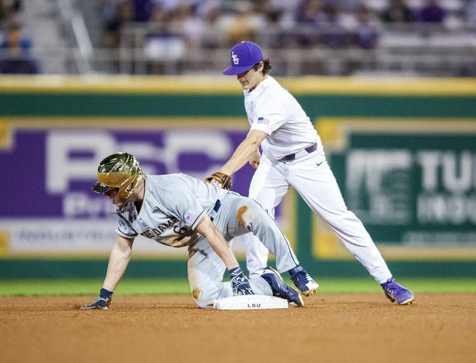 LSU sophomore shortstop Josh Smith (4) attempts to tag out a Notre Dame player during the Tigers' 7-6 victory against Notre Dame on Friday, Feb. 16, 2018, in Alex Box Stadium.