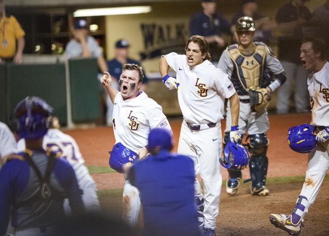 LSU freshman outfielder Nick Webre (23) and sophomore shortstop Josh Smith (4) celebrate after Josh Smith hits a home run during the Tigers' 7-6 victory against Notre Dame on Friday, Feb. 16, 2018, in Alex Box Stadium.