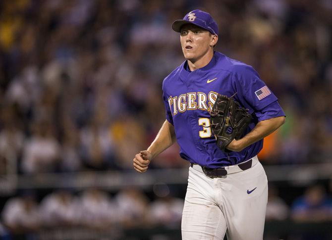 LSU freshman pitcher Zack Hess (38) runs back to the Tigers' dugout after LSU head coach Paul Mainieri issues a pitcher change during LSU's 6-1 loss to Florida in game two of the College World Series on Tuesday June 27, 2017, at the TD Ameritrade Center in Omaha, Nebraska.