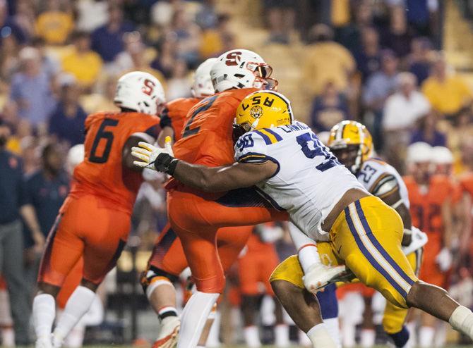 LSU sophomore defensive end Rashard Lawrence (90) tackles during the Tigers' 35-26 win against Syracuse on Saturday, Sept. 23, 2017, in Tiger Stadium.