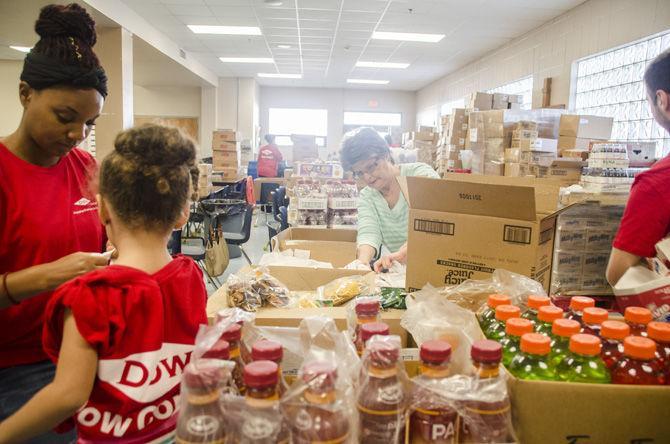 Volunteers assemble brown bag meals to be distributed to those in need on Saturday, March 3, 2018, at The Society of St. Vincent de Paul Baton Rouge at 220 St. Vincent De Paul Drive.