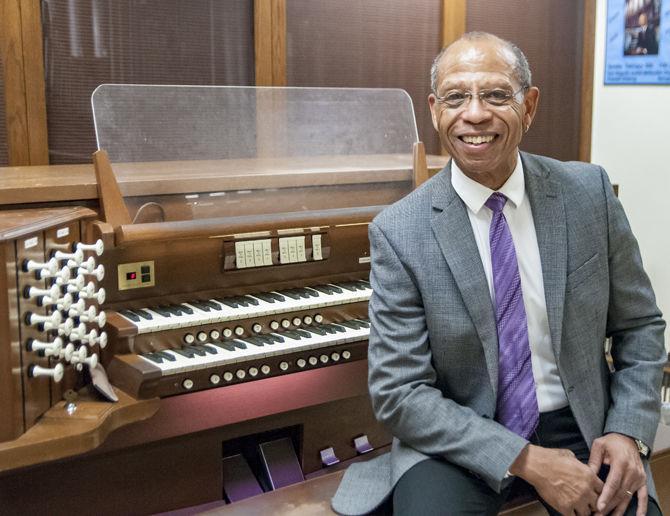 LSU professor of organ studies Herndon Spillman sits next to his organ on Tuesday, Feb. 27, 2018, in the Organ Study room in Hatcher Hall.