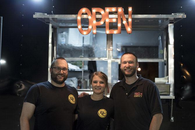 The Big Cheezy co-owners Jason Harbison (left), Kate Busby (middle) and Thomas Jacobs (right) stand proudly in front of The Big Cheezy food truck after opening on Saturday, March 10, 2018 located in Tigerland.