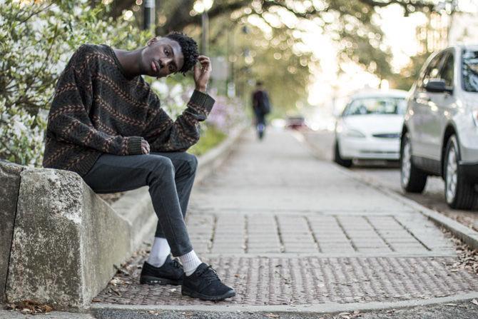 Woodlawn High School student Austin "Wakai" Johnson sits on W. Chimes Street on Thursday, March 8, 2018.