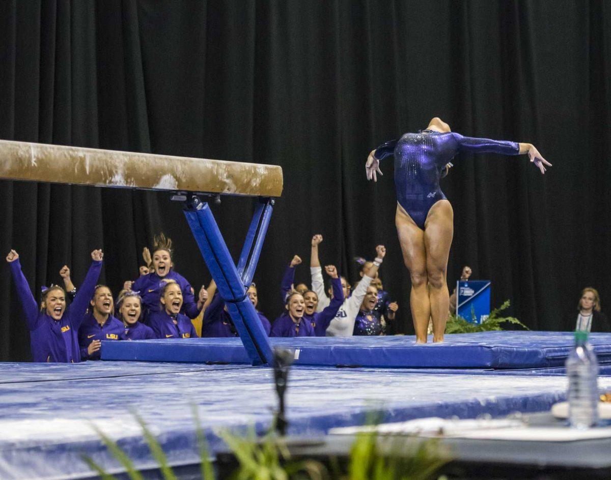 LSU team celebrates as junior Sarah Finnegan finishes her beam routine during the NCAA Gymnastics Super Six on Saturday, April 21, 2018, in the Chaifetz Arena in Saint Louis, Missouri.