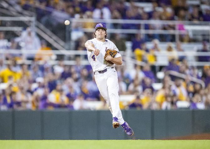 LSU sophomore shortstop Josh Smith (4) throws the ball into first base during the Tigers' 7-6 victory against Notre Dame on Friday, Feb. 16, 2018, in Alex Box Stadium.