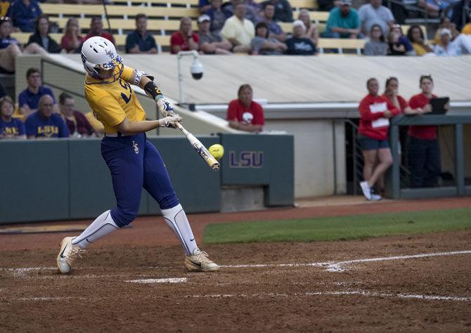 LSU freshman utility Shelbi Sunseri (27) slams the ball for a home run, scorings three runs during LSU&#8217;s 4-0 victory over University of South Alabama at Tiger Park on Tuesday, April 24, 2018.