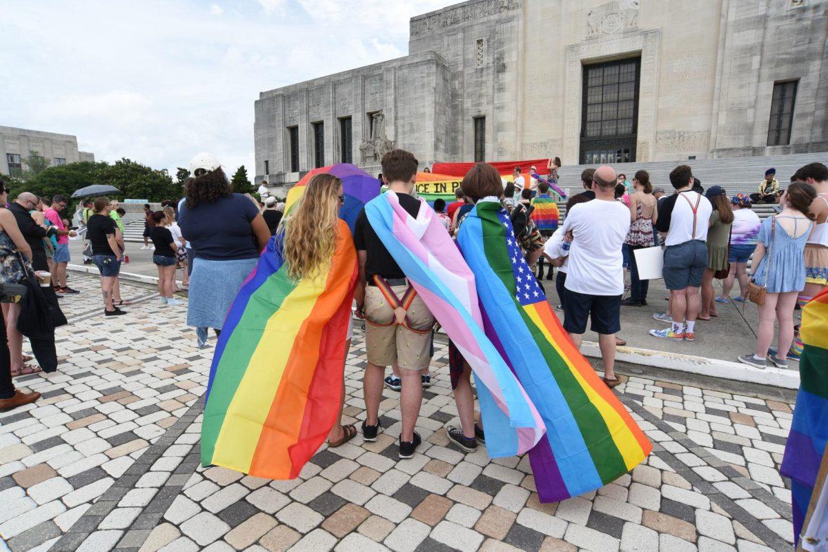 Protestors wear rainbow flags as capes before the 2017 Baton Rouge Pride Fest march.