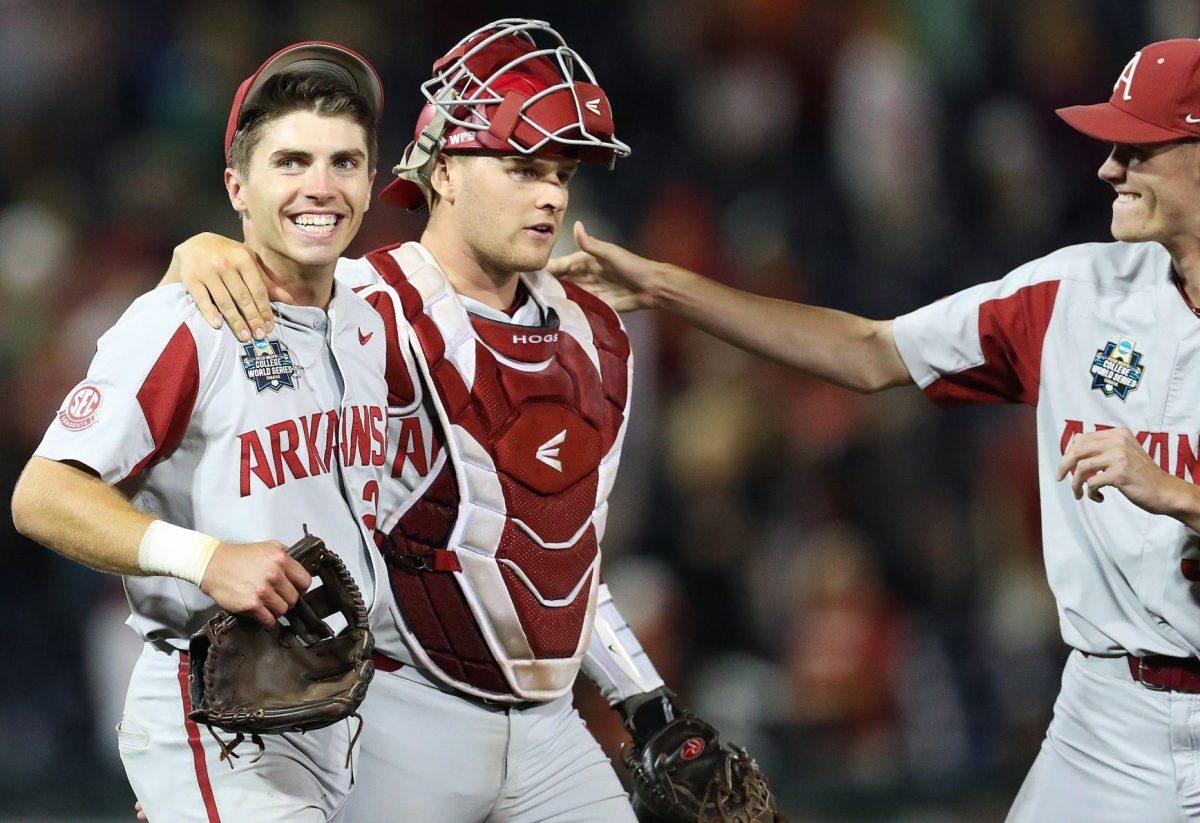 From left: Arkansas' Carson Shaddy and catcher Grant Koch celebrate defeating Florida on Friday, clinching the Razorbacks' first appearance in the CWS championship series since the format began in 2003.