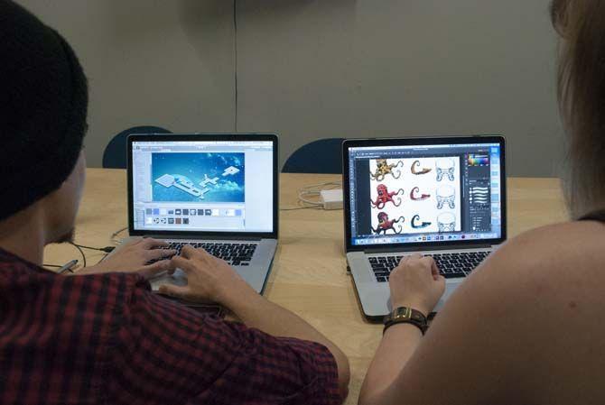 University digital art seniors Cameron Bragg (left) and Tylar Spencer (right) in the process of helping to develop their own video game, entitled "Space Shrimp" on September 7, 2015 at After Hours Lab. LLC.