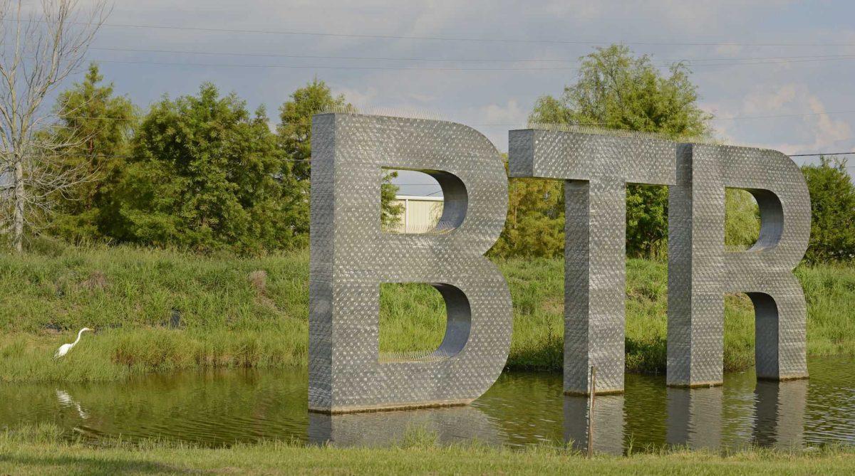 Advocate staff photo by HILARY SCHEINUK -- An egret scours the shoreline of a pond boasting the airport code of 'BTR' at Baton Rouge Metropolitan Airport, Thursday, June 30, 2016.