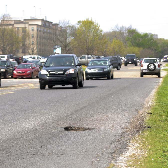 Due to recent budget cuts, LSU roads are left with potholes unfilled on Tuesday March 15, 2016, on LSU campus.