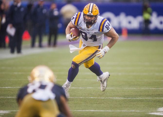 LSU junior tight end Foster Moreau (84) runs with the ball during the Tigers' 17-21 loss to Notre Dame in the Citrus Bowl on Monday, Jan. 1, 2018 in Camping World Stadium in Orlando, Florida.