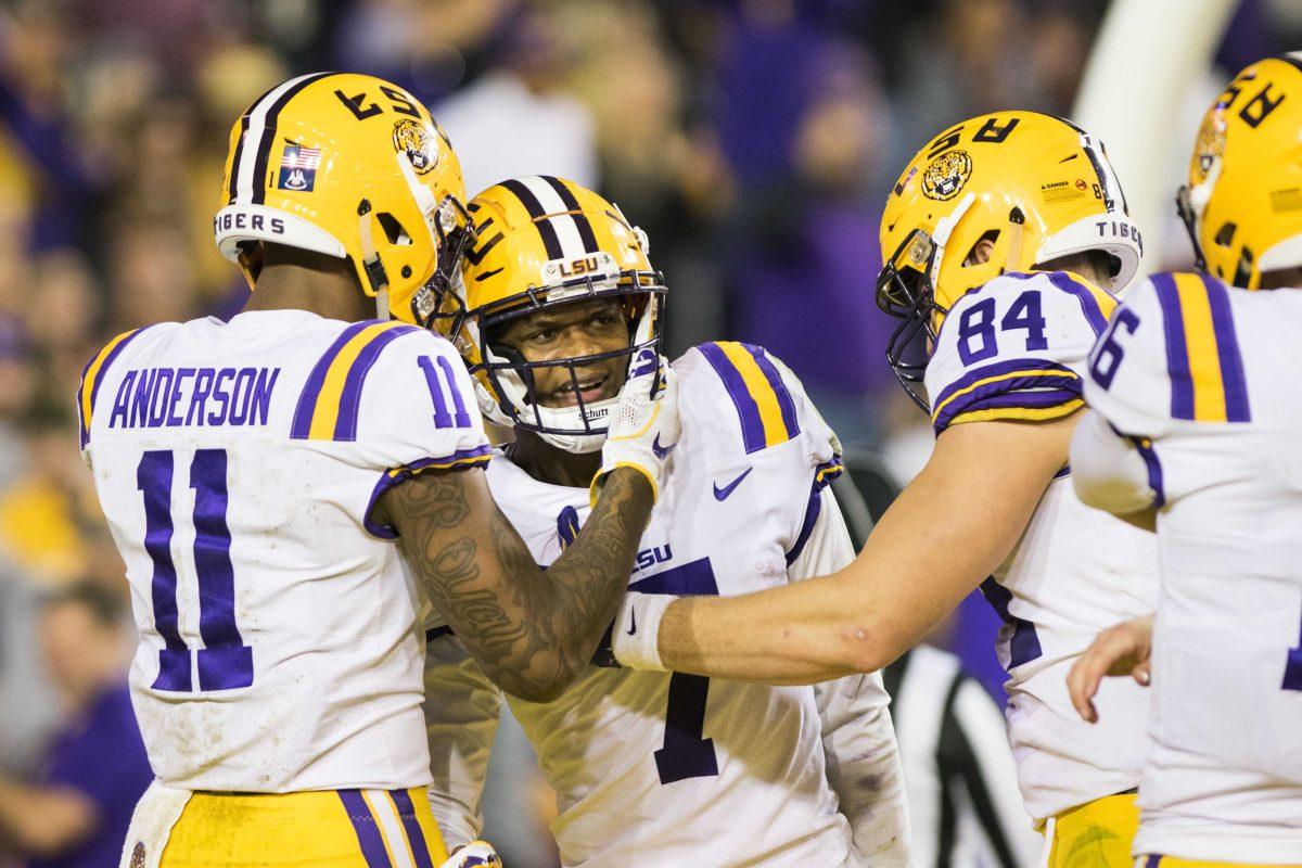 (Left) LSU sophomore wide receiver Dee Anderson (11) and (right) junior tight end Foster Moreau (84) talk to (center) senior wide receiver DJ Chark (7) during the Tigers' 45-21 lead against Texas A &amp; M on Saturday, Nov. 25, 2017, in Tiger Stadium.