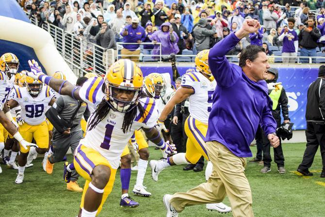 LSU runs out of the locker room led by coach Ed Orgeron during the Tigers' 17-21 loss to Notre Dame in the Citrus Bowl on Monday, Jan. 1, 2018 in Camping World Stadium in Orlando, Florida.