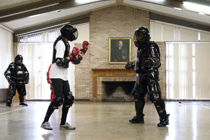 A woman prepares to fight an instructor at Rape Aggression Defense Class, a self-defense course for women, Sunday, Feb. 23, 2014 at the Nelson Memorial Building.