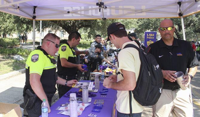 LSU police officers hand out information about safety on campus at the Student Union on Wednesday, Sept. 19, 2018.